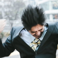 激しく怒る中年部長がスーツ姿で両手を上げた姿の写真