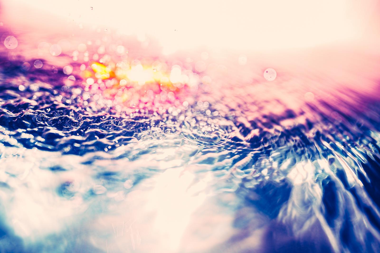 Ripples on the water surface bathed in soft pink light