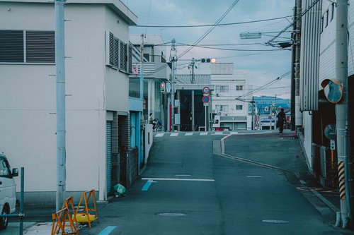 紀三井寺の坂道の先に灯る赤信号と白い建物の町並み