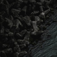 荒々しく並ぶテトラポッドの波消しブロックの写真