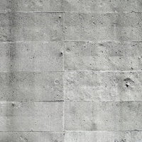 枠板の跡が規則的に走るコンクリート壁のテクスチャーの写真