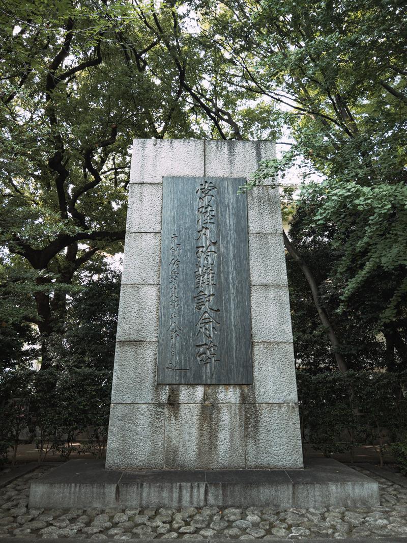 靖国神社の境内にある石製の台座に緑色の銅製プレートが設置された平和の記念碑