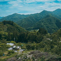 山奥の暮らしを映す谷間の集落と緑の山々が織りなす山村風景の写真