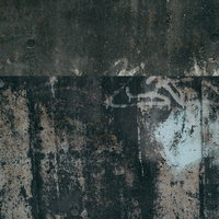 古びた擁壁に描かれた落書きとコンクリートの劣化の写真