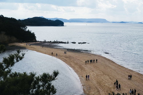 干潮時に現れるエンジェルロードを行き来する観光客