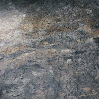 黄土色と灰色が混じった粗い岩壁のテクスチャーの写真