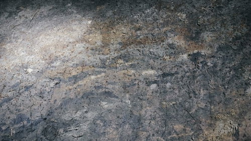 黄土色と灰色が混じった粗い岩壁のテクスチャー