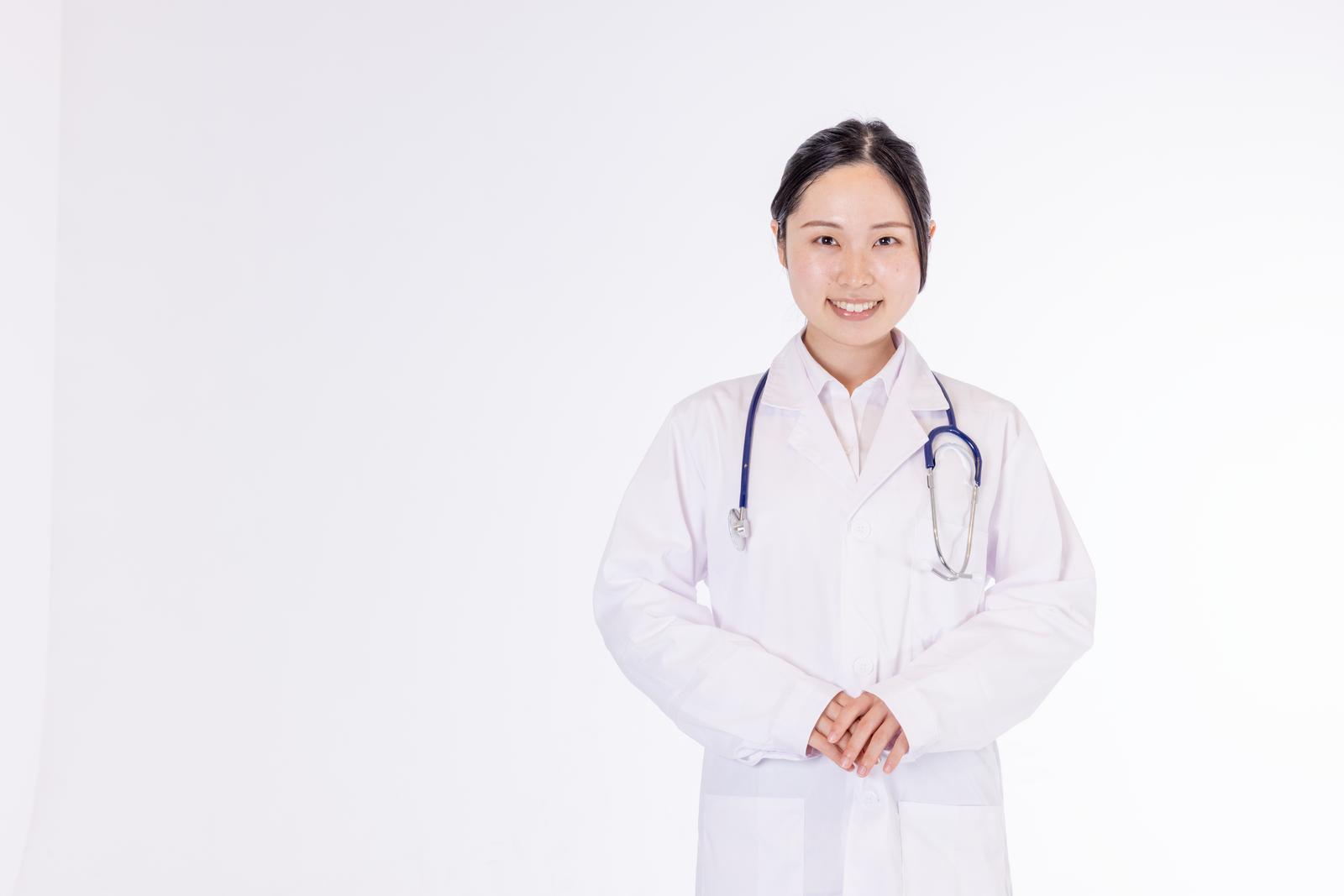 Portrait of a female doctor in a white coat standing with a stethoscope around her neck