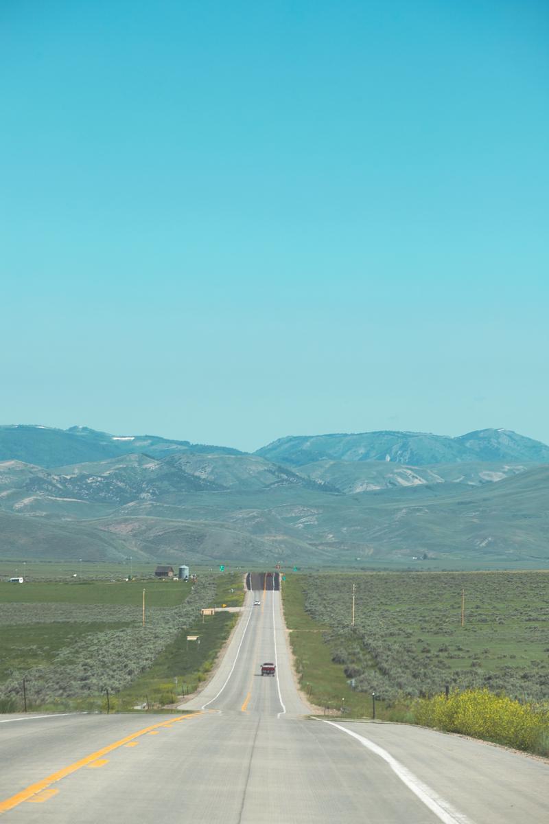 アメリカの直線道路と草原・山脈の遠景