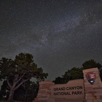 グランドキャニオン国立公園の入口看板と満天の天の川の写真