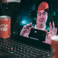 スマホを向けて画面をスクショする男性の写真