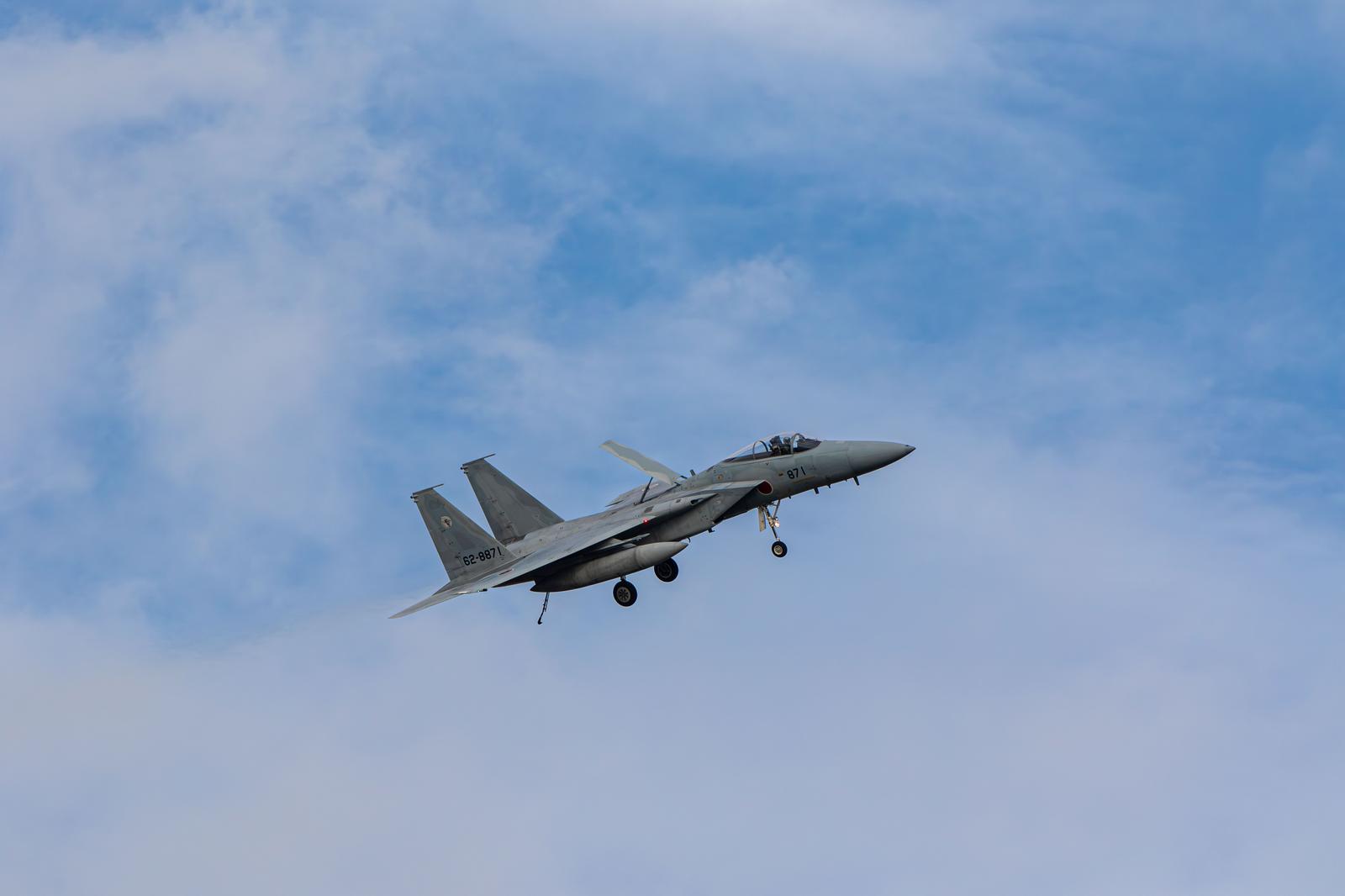 JASDF Fighter Jet Flying through the Sky with White Clouds