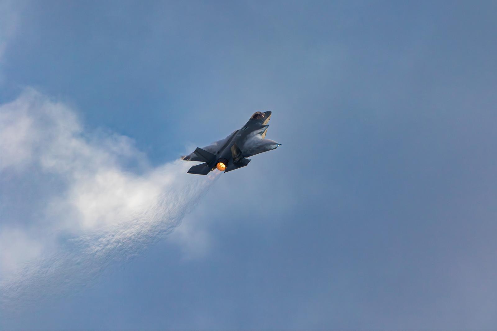 Japan Air Self-Defense Force's Stealthy Fighter Jet F-35 Flying Between the Blue Sky and Clouds