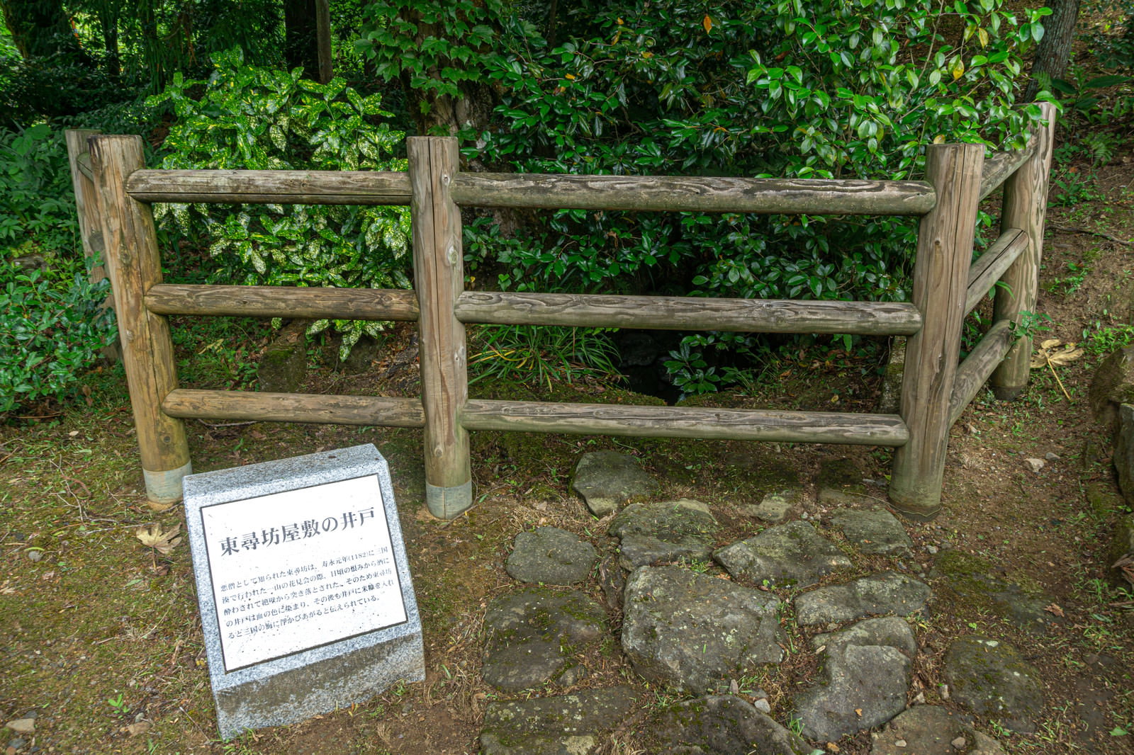 東尋坊屋敷跡の古い井戸と石の説明板