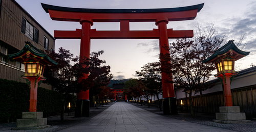 伏見稲荷大社一番鳥居から続くまだ灯篭に灯りが残る早朝の参道