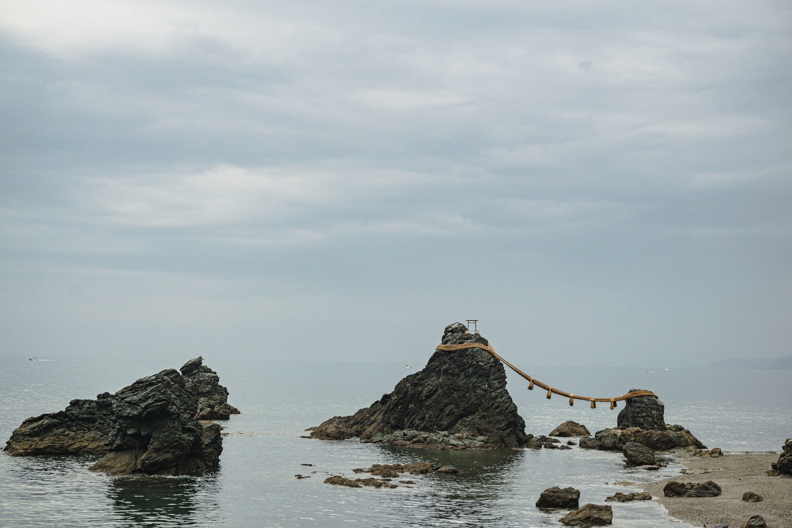 Landscape of the Husband and Wife Rocks on the receding tide under a cloudy sky