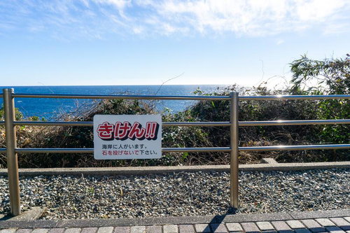 「石を投げないで下さい」海岸の警告看板