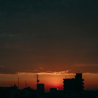 街に沈む夕日と焼けた空の写真