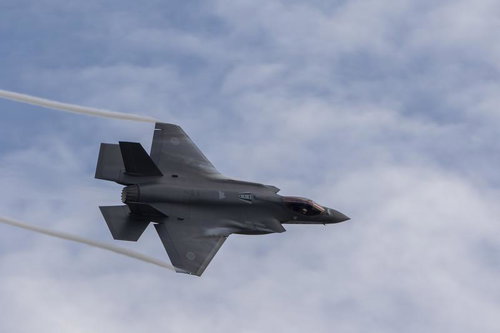 雲が広がる小松基地上空をF35戦闘機が翼の上や翼端からベイパーを発生させて機動飛行を行う