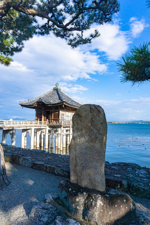 浮御堂を背景にして建つ「比良三上雪さしわたせ鷺の橋」と刻まれた松尾芭蕉の句碑